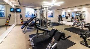 a gym with treadles and weights in a room at Airport Hotel Okęcie in Warsaw
