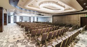 a conference room with rows of chairs and a podium at Airport Hotel Okęcie in Warsaw