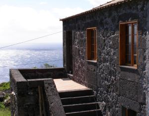 a house with a view of the ocean at Casa do Bernardo in Feiteira +6 photos