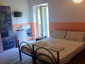 a bedroom with a bed and a chair in it at Ostello Residenza Molinatto in Oggiono