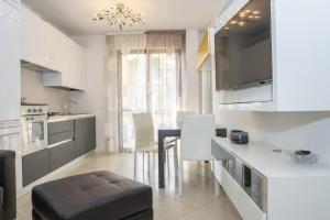 a kitchen with a table and chairs in a room at Fellini - Family Flat in Rimini