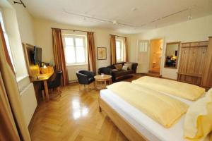 a bedroom with a large bed and a living room at Alte Post in Lindau