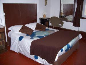 Säng eller sängar i ett rum på Auberge Cocagne