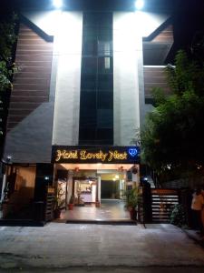 a building with a sign that reads hotel lobby mess at Hotel Lovely Nest in Coimbatore