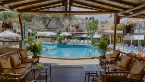a large swimming pool with chairs and a table at Hosteria Suiza in Ica