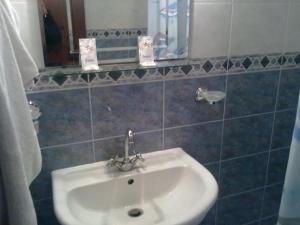 a bathroom with a white sink and a mirror at Apartment Pier in Varna City