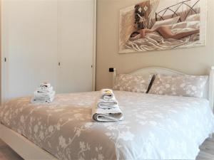 a bedroom with a bed with two pairs of slippers at Lago d'Idro - Casa Emma in Ponte Caffaro