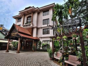 a large building with a courtyard in front of it at City River Hotel in Siem Reap