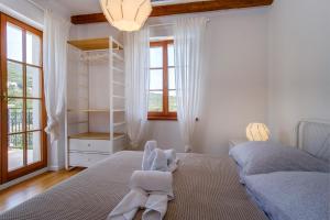 a bedroom with two beds and a chandelier at Villa Sveti Jakov in Sveti Jakov +100 photos