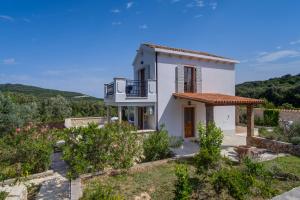 a villa with a view of the garden at Villa Sveti Jakov in Sveti Jakov