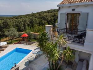 a villa with a swimming pool and a house at Villa Sveti Jakov in Sveti Jakov
