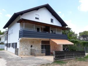 a white house with a black roof at Casa Gudelj in Pirovac
