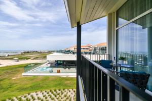 an outdoor balcony with a view of the ocean at La Grande Terrasse Hotel & Spa La Rochelle - MGallery Collection in Châtelaillon-Plage
