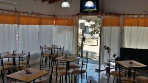 a room with tables and chairs and a large window at Hotel Rincon Serrano in San Agustín de Valle Fértil