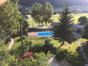 an aerial view of a house with a pool and trees at Hotel La Prairie in Méaudre