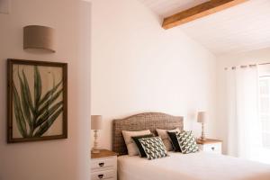a bedroom with a bed and a picture on the wall at Herdade das Barradas da Serra in Grândola