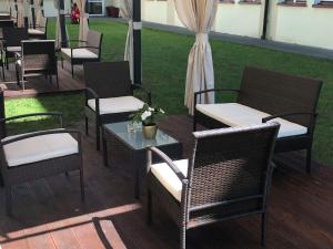a group of chairs and tables on a patio at Hotel Holiday Park in Warsaw