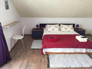 a bedroom with a bed with a red blanket at Apartment Inter Vivos in Smokvica