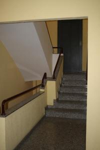 a hallway with stairs in a building with a door at Ap-Art in La Seu d'Urgell