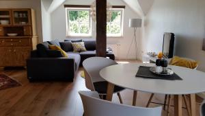 a living room with a table and a couch at Schlossblick Herborn in Herborn
