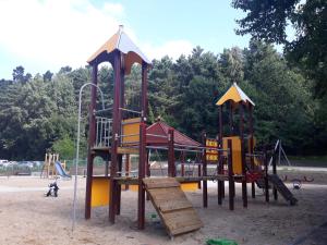 a playground with a slide and a play structure at Traper Apartamenty in Sopot