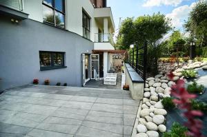 a house with a pathway leading to the front door at Hotel Falcon in Rzeszów