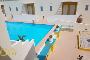 a swimming pool in the middle of a building at Hotel Sole in Lampedusa