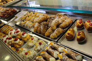 a display case with many different types of pastries at Rocca degli Etnei in Paterno