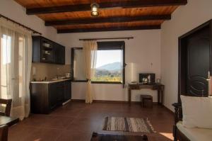 a kitchen with a large window and a sink at Madares Apartments Anopolis in Anopoli Sfakion