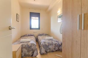 A bed or beds in a room at Boadella ATICO - SEAVIEW PENTHOUSE