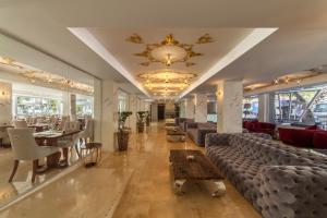 a lobby with couches and a table and chairs at Essence Hotel Boutique in Torremolinos