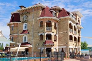 a large brick building with a clock on it at Marseille Resort in Zatoka