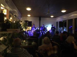 a group of people sitting in a room playing music at Fredensborg Vandrerhjem, i Kongens baghave in Fredensborg