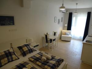 a bedroom with a bed and a kitchen and a table at Job studio apartments in Split
