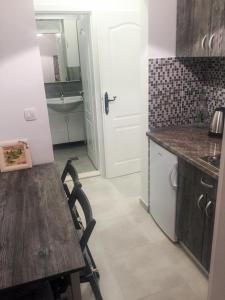 a kitchen with a wooden table and a sink at Apartments Pomeštak in Pomena