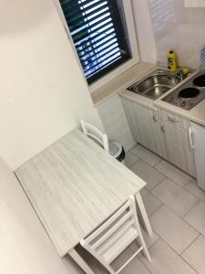 a small kitchen with a table and a sink at Apartments Pomeštak in Pomena +14 photos
