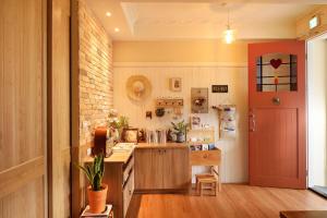 a kitchen with a counter and a red door at Good day in Hualien City