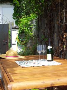 a table with two glasses and a bottle of wine at Haus Seegarten in St. Wolfgang