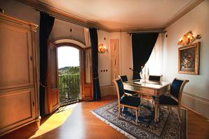 a dining room with a table and chairs and a balcony at Albergo La Lanterna in Sarteano