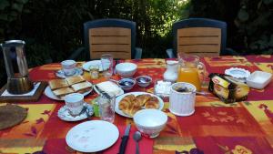 a table with plates of breakfast food on it at Oniros in Neuffontaines