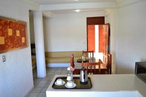 a kitchen with a table with a tray of food at Hotel Campestre Inn in Le&oacute;n