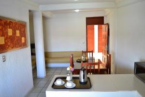 a kitchen with a table with a tray of food at Hotel Campestre Inn in León
