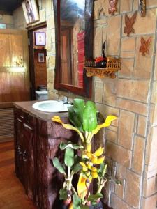 a bathroom with a sink and a tree in it at Klongsai Hills in Wang Nam Khieo