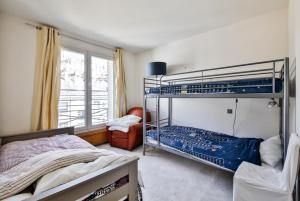 a bedroom with two bunk beds and a window at Eiffel Terraces in Paris