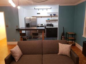 a living room with a couch and a kitchen at Blue Penthouse in the City in Atlanta