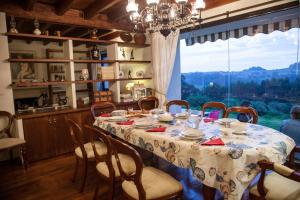 a dining room with a table and chairs and a window at Abelardo's Home in Ribadesella
