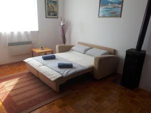 a bedroom with a bed with two blue pillows on it at Apartment Hana in Crikvenica