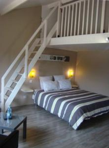 a bedroom with a bed and a staircase at LB et LB in Beaune
