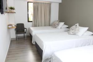 Postel nebo postele na pokoji v ubytování Hotel Boutique Plaza