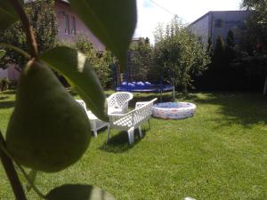 two chairs and a table in a yard at Elite Apartment Jasmina in Bihać